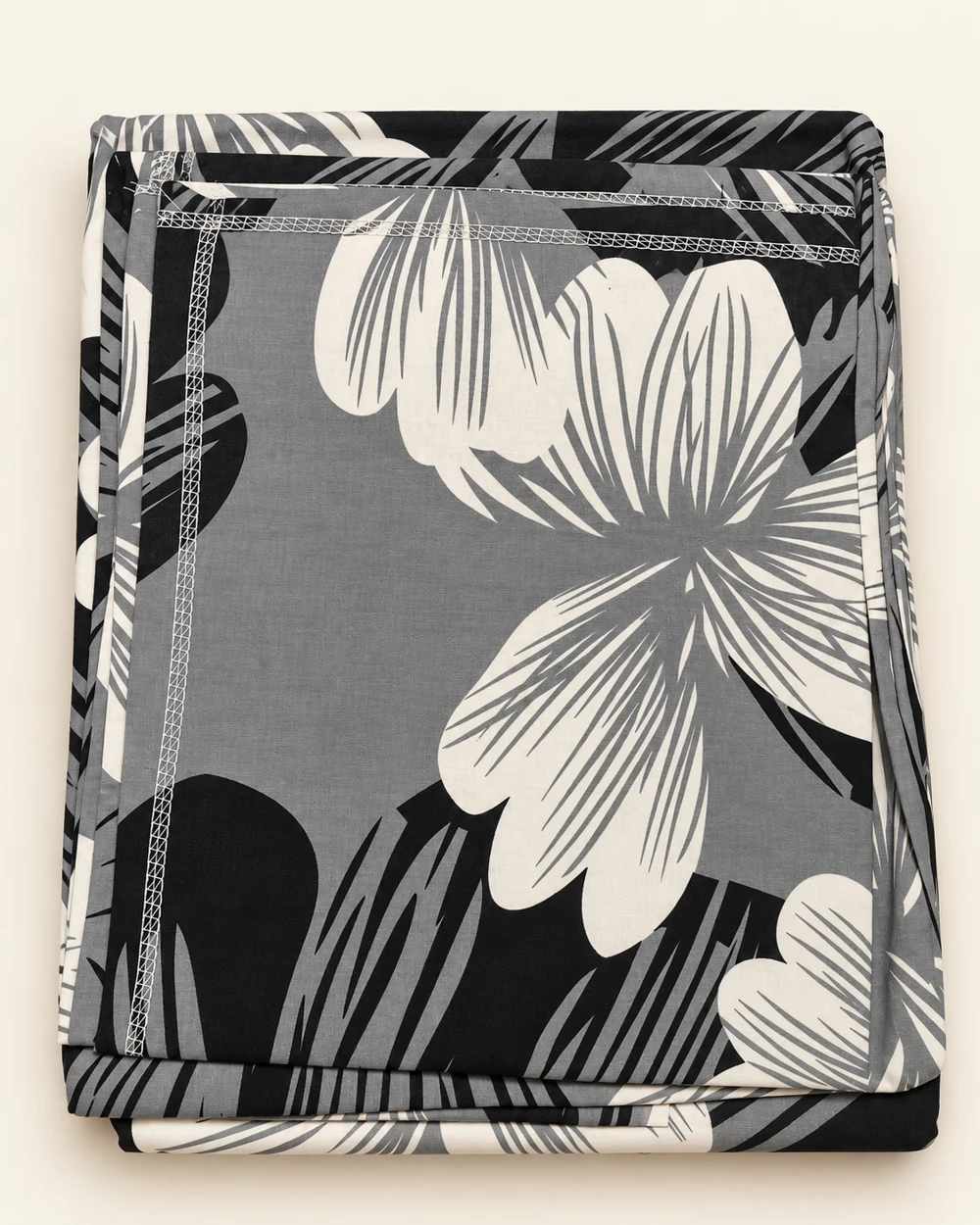 Monochrome Petals printed bedsheet, folded to show its design